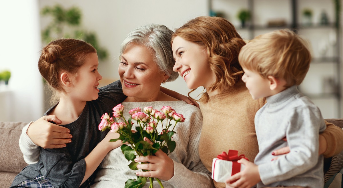 Grandmother Mother and children with flowers and gift. Mother's Day Gift Idea