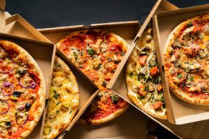 Top view of pizzas in delivery boxes