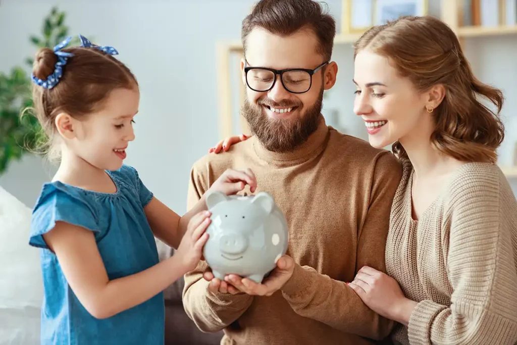 the parents teaching their kid about money savings with piggy bank-money box